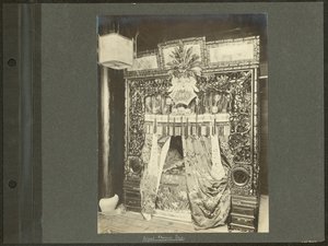 Canopy Bed with Elaborately Carved Wooden Bed Post and Silk Drapes by Unknown